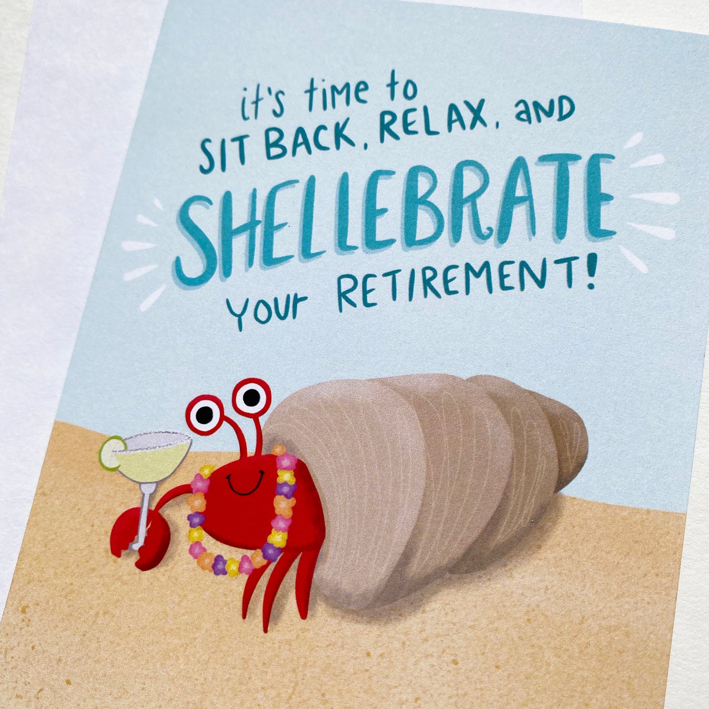 Tropical Retirement Card with a crab holding a margarita that says "it's time to site back, relax and shellebrate your retirement!
