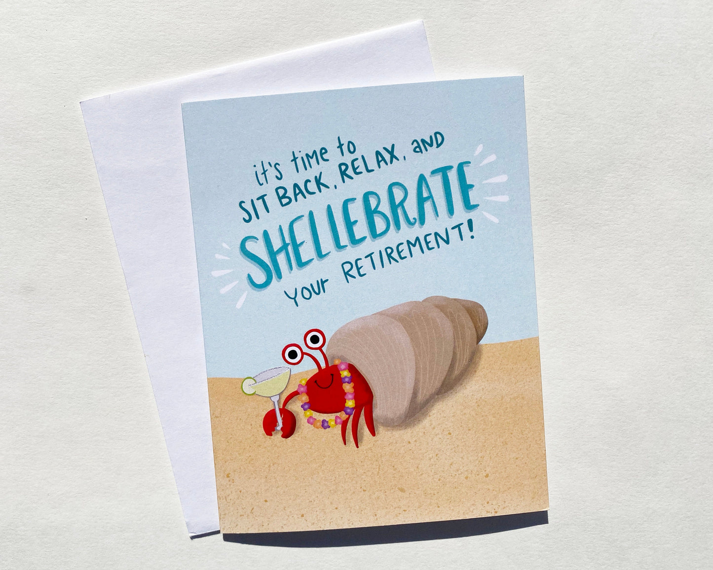Tropical Retirement Card with a crab holding a margarita that says "it's time to site back, relax and shellebrate your retirement!
