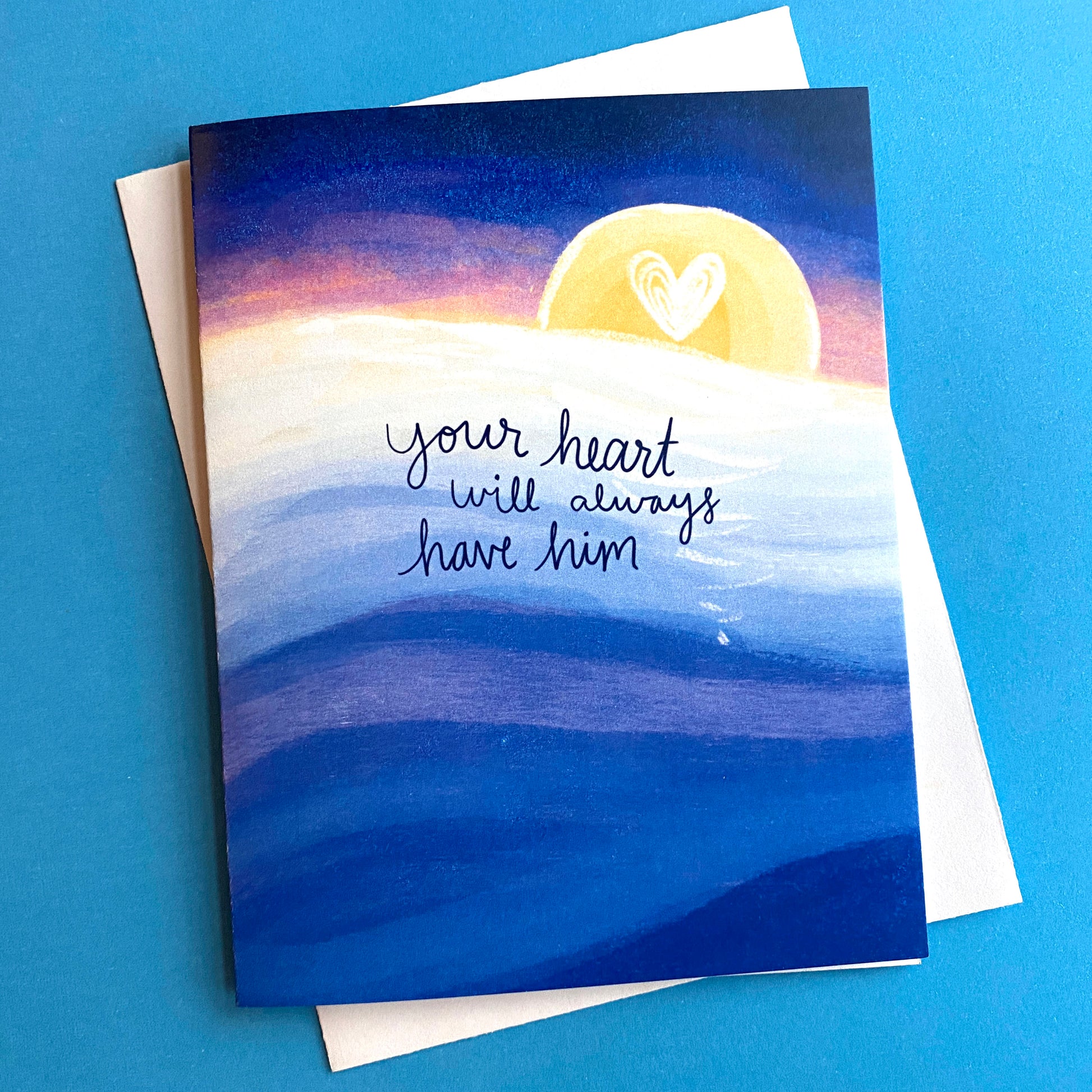 Sympathy card that has a calm ocean and sunset and it says "your heart will always have him".