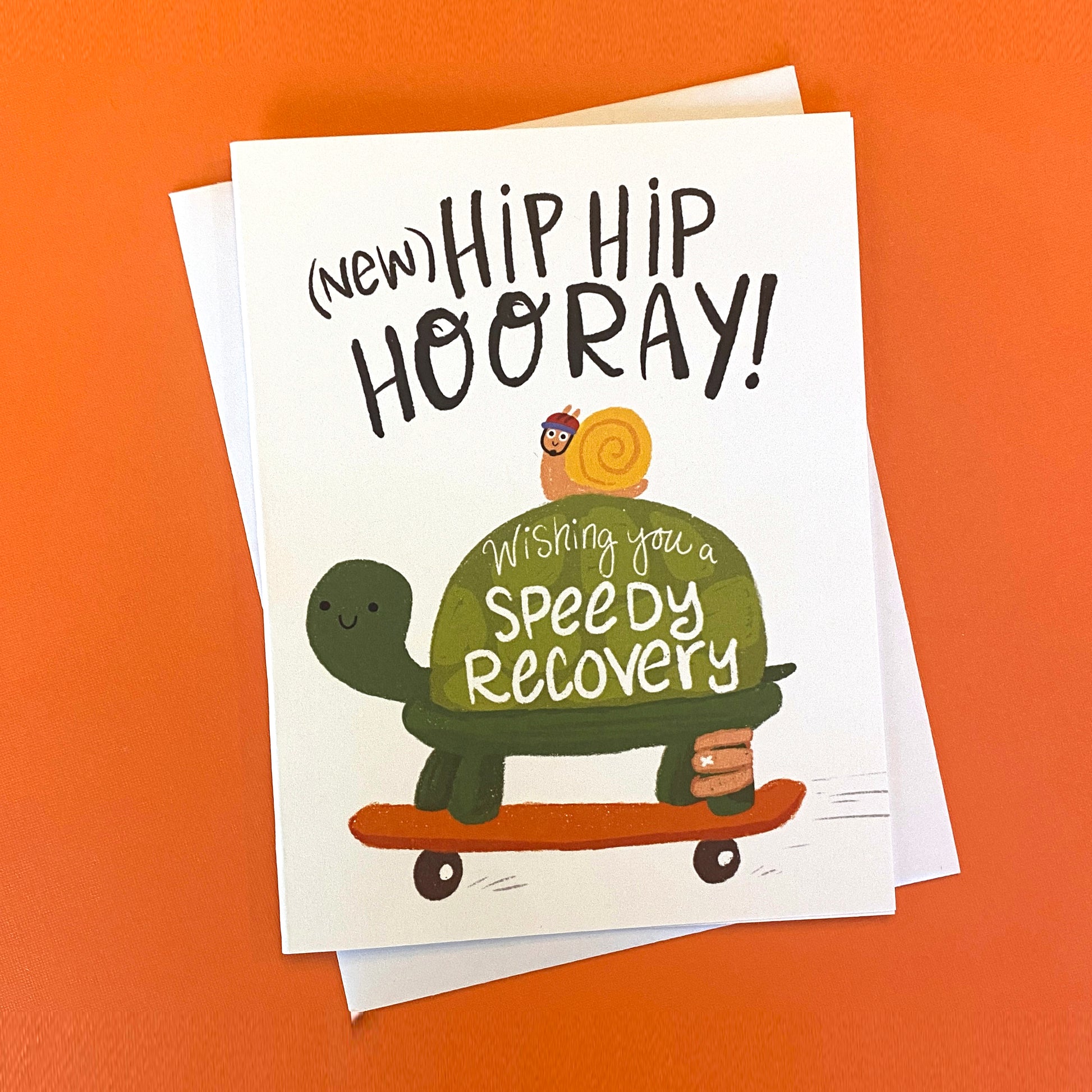 Get well greeting card with a cute turtle on a skateboard. It reads "new hip hip hooray wishing you a speedy recovery". 